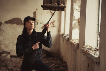 airsoft woman soldier with a rifle playing strikeball In an abandoned old building