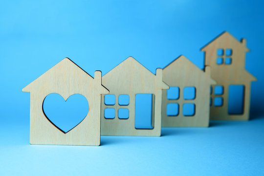 How to choose a house. Different houses with windows on blue background. Wooden house with heart.
