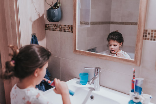 Child brushing teeth with an electronic toothbrush