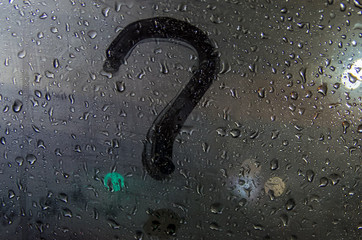Autumn rain, the inscription on the sweaty glass - question mark