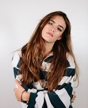 1980's womans studio portrait with era specific blue and white striped sweatshirt