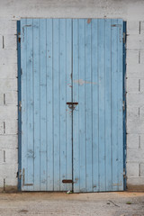 Old blue wooden doors. Warehouse entrance.