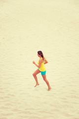 Young woman running on the beach