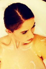 Woman relaxing in bathtub with bubble