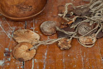 Clay pottery and ceramic products on a wooden table. Home workshop. Handmade with drawings and patterns.