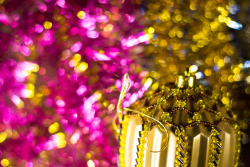 Abstract Christmas bokeh background. Unfocused tinsel with handmade toy close up.