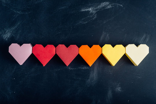 Rainbow paper hearts in a row