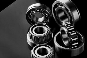 Close-up of a set of ball and roller bearings on a dark background