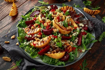 Poster Grilled quince salad with baked and fresh grated beetroot, blue cheese, walnuts on wooden rustic table © grinchh