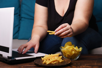 mindless snacking, overeating, lack of physical activity, laziness, homebody. fat overweight woman...