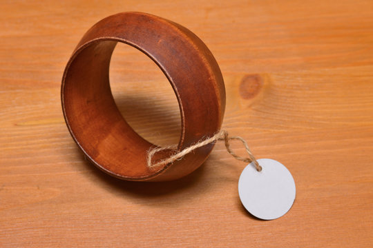 bracelet from a tree on a wooden background, with a label