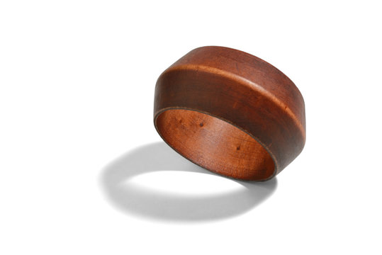 wooden bracelet made of an integral piece of a tree with a shadow isolated on a white background