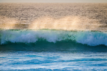 beautiful  wave on the ocean in tenerife while a long oceanic foam is coming. ground view landscape and water waves with nobody. vacation outdoor and power concept