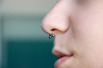 Nose Piercing septum. side view with copy space for text