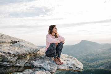 Young woman resting on rock
