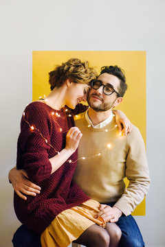 Loving couple wrapped with garland