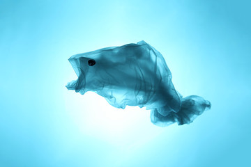Obraz premium Plastic bags and garbage in the sea and ocean. Suffering sea animals. Fish symbol out of waste.