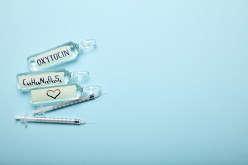 Obraz premium Oxytocin in ampoules. Decrease hormone and diagnostics. Heart and love concept. Copy space for text.
