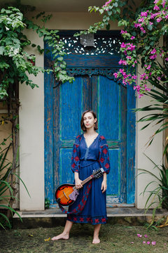 Young girl holding a ukulele