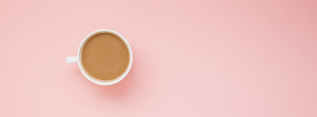 Cup of coffee with milk on pink background