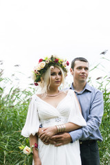 photo session of a girl in a wreath and her boyfriend love story in nature