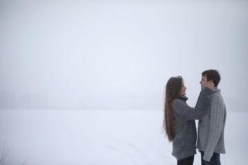 pair of lovers on a date winter afternoon in a snow blizzard