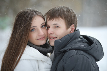 pair of lovers on a date winter afternoon in a snow blizzard