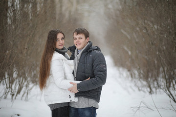 pair of lovers on a date winter afternoon in a snow blizzard