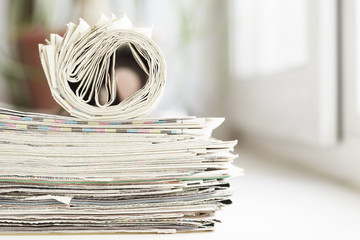 News - Newspapers folded and rolled, side view