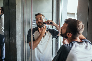 Man Shaving His Beard at Home