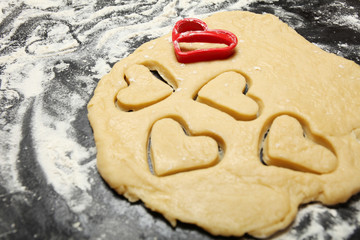 Cooking homemade cookies in the shape of hearts. Preparing for St. Valentine's Day.