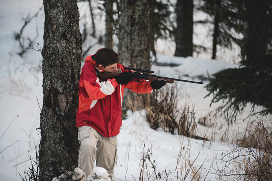 A Teen Boy At Play With An Air Soft Gun In The Woods