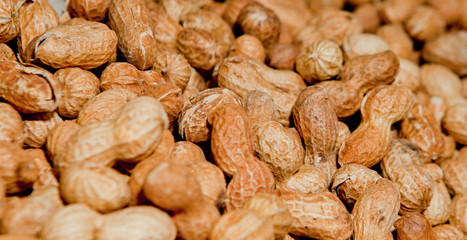 Peanuts in shell texture background. Raw peanuts on display at a farmer's market
