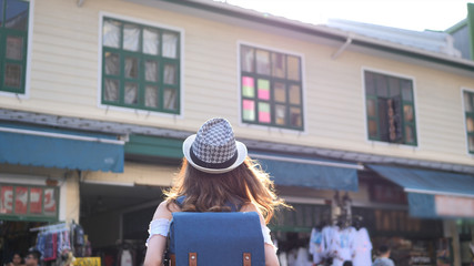 Back side of Young traveling women with backpack in city centre are walking Khaosan Road walking...