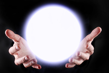 Hands and a glowing sphere between them