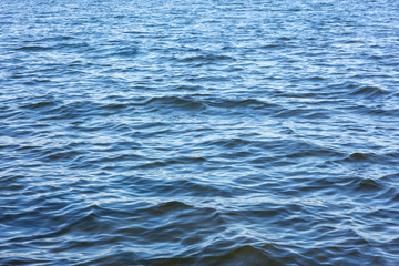 Small waves on the river in clear weather. Background.