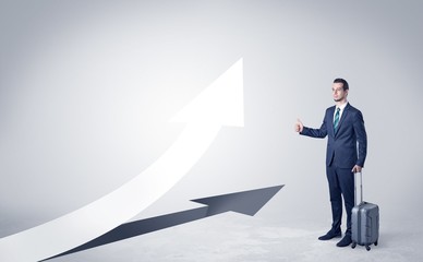 Young businessman hitchhiking with progressive arrow concept and copyspace
