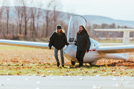 Friends pulling glider from the runway after flight