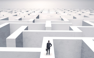 Small businessman in a middle of a huge maze
