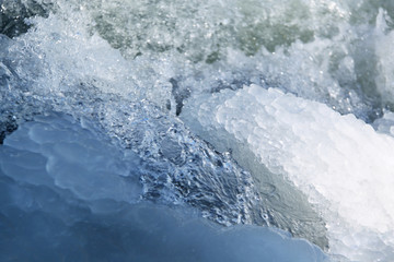 Fototapeta premium Beautiful blue ice at frozen waterfall, closeup, winter background