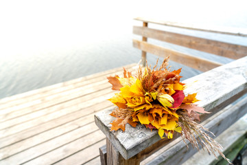 Flower Bouquet Handmade of  Autumn Leaves on a Pier