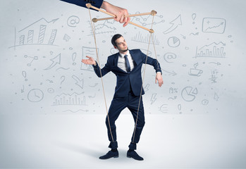 Puppet employee controlled by a big hand with documents and staffs around
