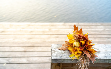 Flower Bouquet Handmade of  Autumn Leaves on a Pier