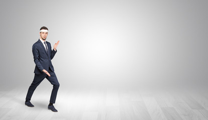 Young businessman in suit fighting in an empty space
