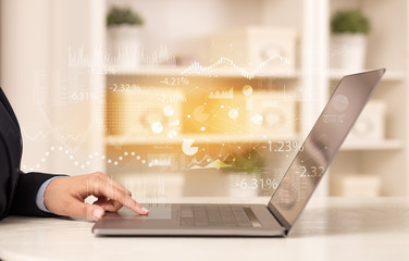 Business woman in homey environment using laptop with financial report concept
