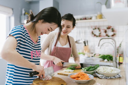 Young chinese women cooking at home