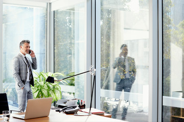 Businessman Talking On Mobile Phone At Office