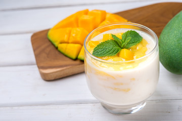 Fresh mango juice and mango fruit on white background