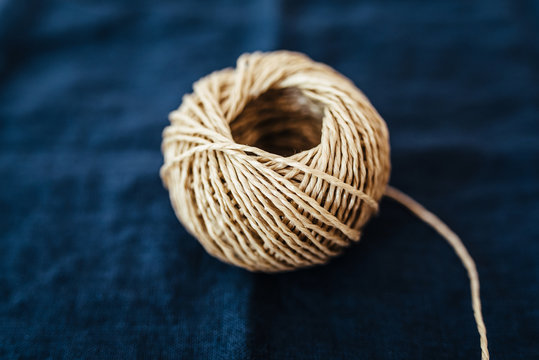 Coil of parcel string on fabric background