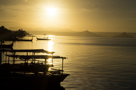 Talisay, Batangas, Philippines - December 25, 2015: Tourist Boat anchored at Lakeshore seen during sunrise that cater to interisland tourist travelers. Silhouettes